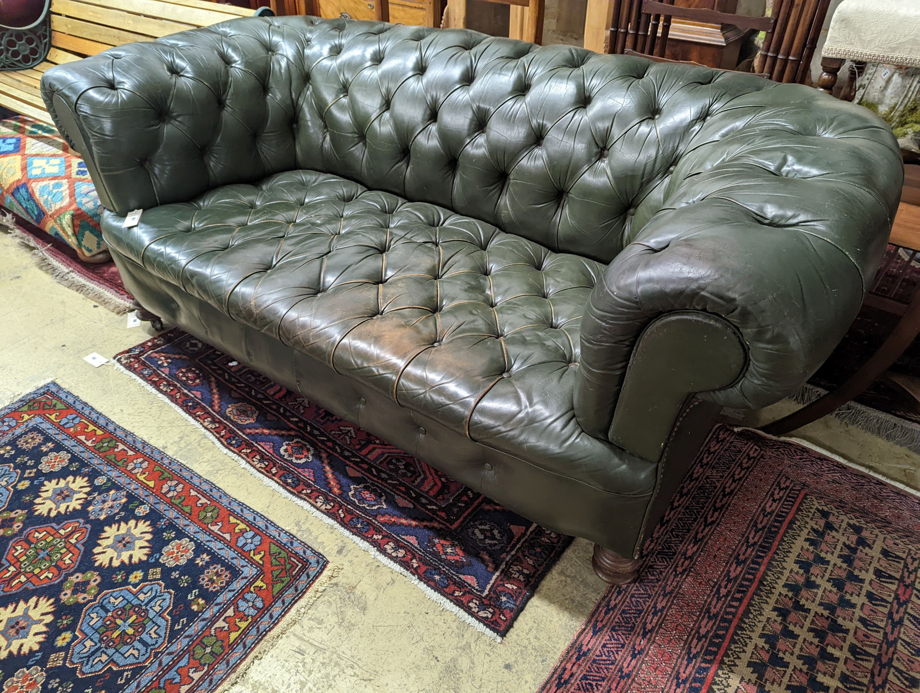 A late Victorian buttoned green leather Chesterfield settee, length 184cm, depth 82cm, height 70cm